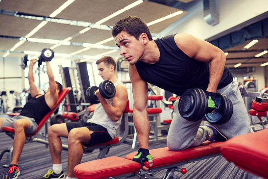 Three Men With Dumbbells In The Gym