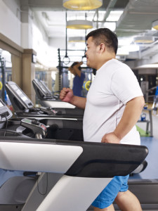 Overweight Man Exercising On Treadmill